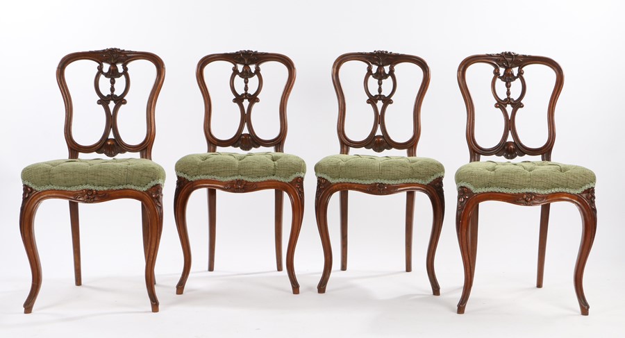 Set of four Victorian walnut parlour chairs, the foliate carved cresting rails above shell and