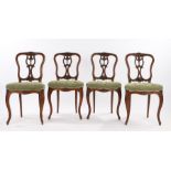 Set of four Victorian walnut parlour chairs, the foliate carved cresting rails above shell and