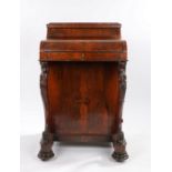 Victorian rosewood Davenport, the pop-up top above a shaped fall opening to reveal a tooled