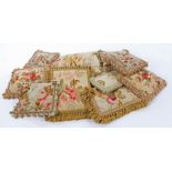 A collection of ten Aubusson tapestry cushions, each on a pale green ground with floral decoration