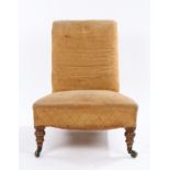 Victorian nursing chair, with upholstered back and seat, raised on turned front legs with brass