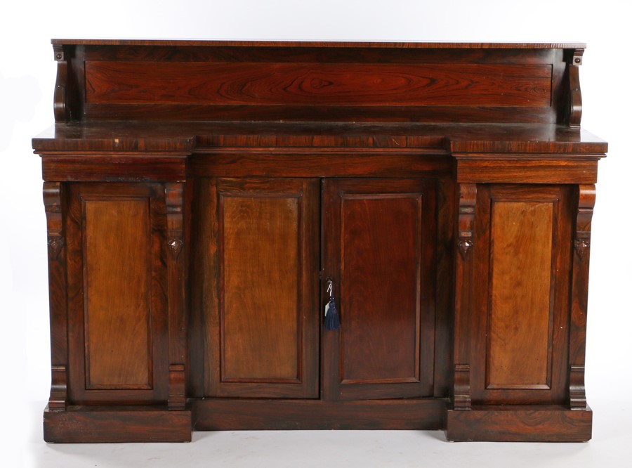 William IV rosewood breakfront cabinet, the top supported on S-scroll capitals above a breakfront