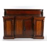 William IV rosewood breakfront cabinet, the top supported on S-scroll capitals above a breakfront