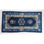 Semi antique Chinese rug, the blue ground with foliate decoration, 142cm x 76cm