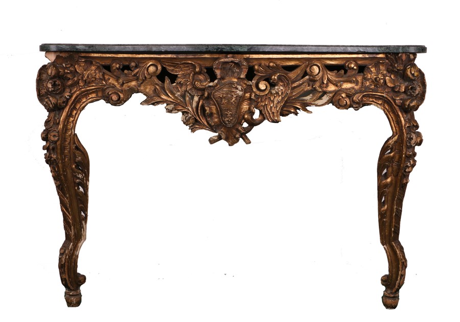 Marble and giltwood console table, the serpentine marble top above a carved shield flanked by