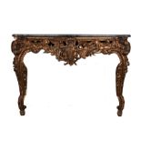 Marble and giltwood console table, the serpentine marble top above a carved shield flanked by