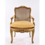 19th Century French giltwood fauteuil in Louis XV style, the foliate cresting above a cane back with