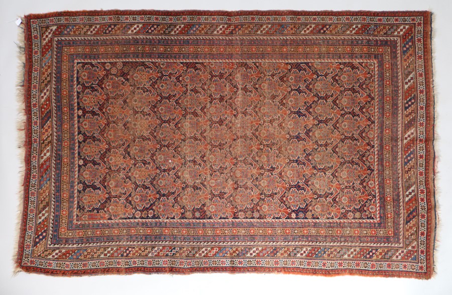 Old Persian Shirvan carpet, the red ground with multiple borders and tasselled ends, 226cm x 152cm