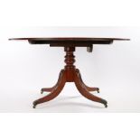 Regency mahogany breakfast table, the oval top with reeded edge above a turned column and four