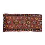 Modern Darabi Kilim rug, the maroon ground with diamond lozenge pattern centre and tasselled ends,