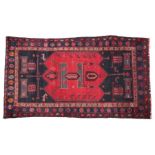 Modern Perisan Hamadan carpet, the red ground with black corners, with foliate and animal