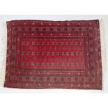 Modern red Afghan rug, the red ground with lozenge pattern centre, 168cm x 124cm