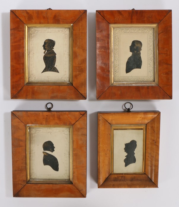 Collection of four 19th Century silhouettes, to include a gilt heightened gentleman, another, a lady