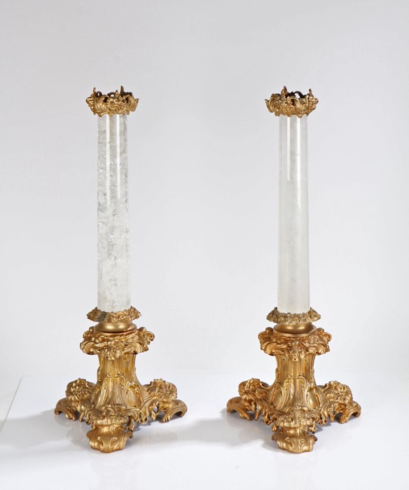 Pair of rock crystal and ormolu table lamps, the foliate and scroll decorated ormolu caps above