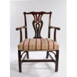 George III mahogany armchair, the undulating top rail with scroll ends above a shaped splat back and