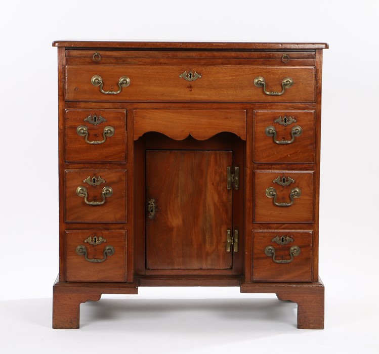 George III mahogany kneehole desk, with brushing slide above a long frieze drawer, the kneehole with