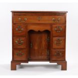 George III mahogany kneehole desk, with brushing slide above a long frieze drawer, the kneehole with