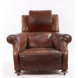1920's leather deep armchair, with a large arched head rest and deep seat flanked by arms and raised