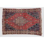 Moslaghan rug, the stepped tomato red field with camel coloured medallion within typical indigo