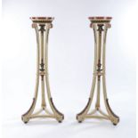 Pair of neoclassical style cream painted candlestands, with faux porphyry tops above leaf