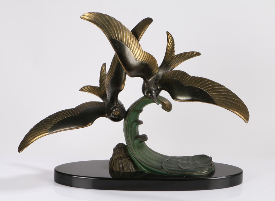 Trebig, an Art Deco patinated bronze group of two seagulls flying over a wave, signed Trebig to