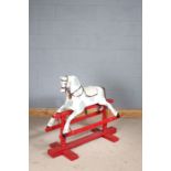 Early 20th century wooden rocking horse, later painted in white and grey on a red base, 110cm long