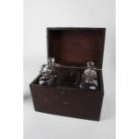 19th century mahogany decanter box, the hinged lid enclosing a silver plated stand, four glass