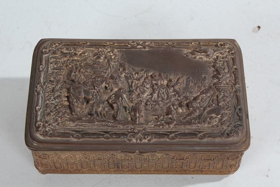 Early 20th Century gilt metal casket, the hinged lid depicting figures and horses in a landscape