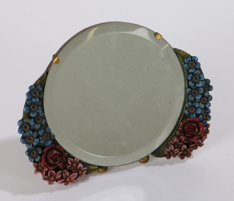 Barbola easel mirror, of circular form, with painted flowers either side in blue and red, with