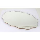 Mid 20th Century wall mirror, of wavy shaped form with bevelled glass mirror, 69cm wide