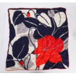 Ladies silk scarf, printed with a red flower on a navy, silver and white ground, signed to bottom