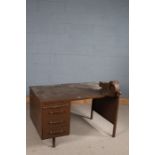 Industrial metal desk, painted in brown, with vice and fitted three drawers, 121.5cm wide x 76cm