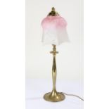 Brass table lamp with a shaped mottled glass shade in pink and white, 54cm high