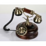 Modern cradle dial telephone, with circular wooden base