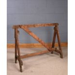 Rustic stained pine trestle, united by stretchers, 120cm long x 90cm high