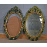 Pair of 20th Century decorative mirrors, each of oval form with painted grape and vine borders, (one