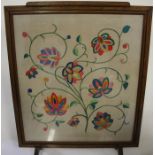Mid 20th Century oak framed fire screen, inset with a brightly coloured floral embroidered panel