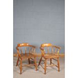Pair of 20th century elm seated tub chairs, having spindled back and legs united by stretchers (2)