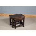 Nest of three Arts and Crafts style oak occasional tables, having chamfered legs and chip style