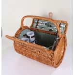 Wicker picnic hamper, of round form with carrying handle, complete with contents, 49cm wide