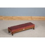 Arts and Crafts style oak oblong stool, having red leather and studwork upholstery, block legs and