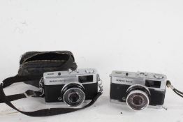 Two Olympus Trip 35 cameras, with f/2.8 40mm lenses, one housed in a canvas bag (2)