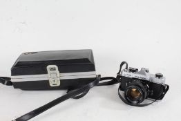 Fujica ST705 camera, with a Fujinon f/1.8 55mm lens, housed in a shell case