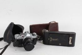 Canon AV-1 camera, with a f/1.8 50mm lens, and a Kodak No. 1A Pocket Brownie, both in leather