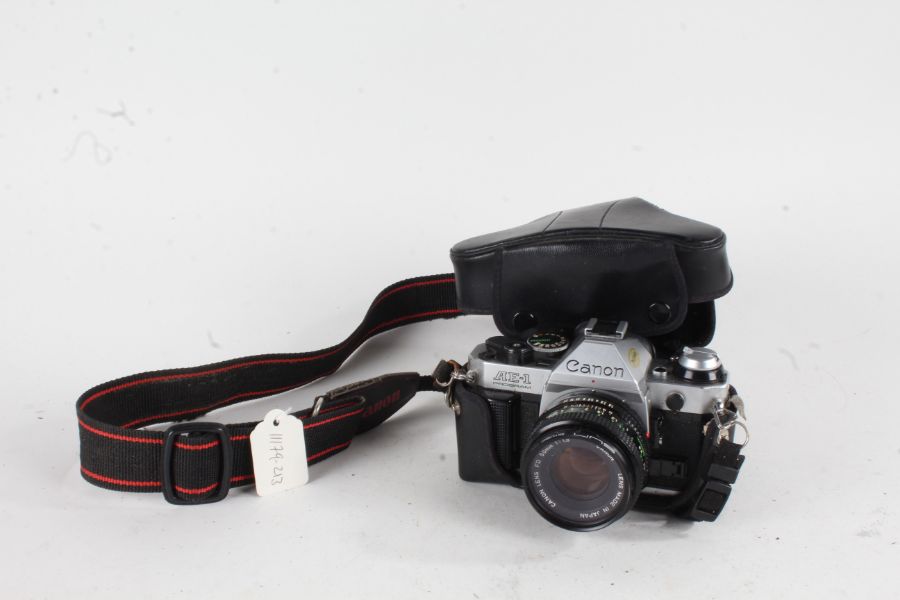 Canon AE-1 Program camera, with a f/1.8 50mm lens, in a black leather case