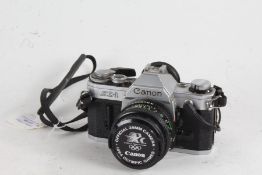 Canon AE-1 camera, with a FD f/1.8 50mm lens, 1984 Olympic Games lens cap and a Canon Data Back A
