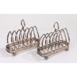 Pair of silver plated six slice toast racks, the pierced arched finals above arched divides,