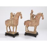 Near pair of Chinese pottery horse and riders, Tang Dynasty, with pale red painted bodies with