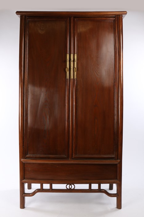 Chinese chestnut tapered cabinet, Qing Dynasty, the moulded cornice above the pair of tapering doors