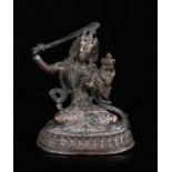 Tibetan copper alloy figure of Manjushri, possibly 18th Century, the bodhisattva of wisdom seated in